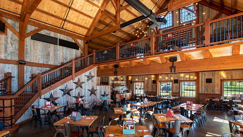 View of ground level dining room with staircase that leads to upstairs dining room